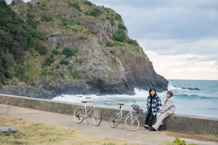 レンタサイクルで休憩する観光客